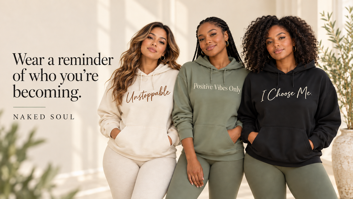 Three women wearing Naked Soul affirmation hoodies beneath the headline Wear a reminder of who you’re becoming.